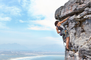 Rock climbing, travel and blue sky with woman on mountain for adventure, cliff and space. Strong,...