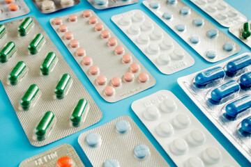 Colorful of tablets and capsules pill in blister packaging arranged with beautiful pattern with flare light. Pharmaceutical industry concept. Pharmacy drugstore