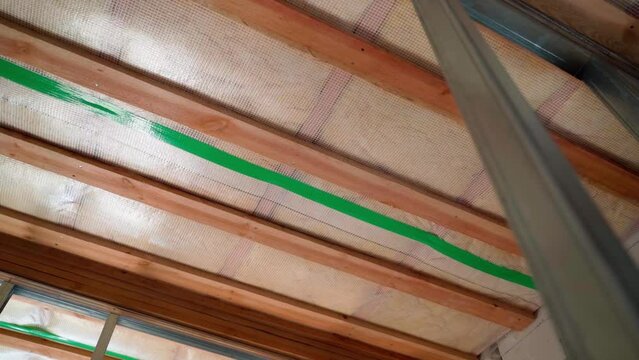 The roof of a private house insulated with glass wool, inside view from below