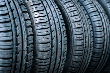Car tires and wheels in a transport storage warehouse or car service. New tires background