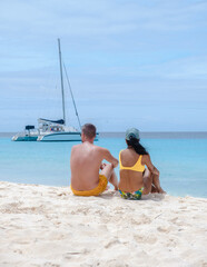 Fototapeta premium Klein Curacao Island with Tropical beach at the Caribbean island of Curacao Caribbean, a couple of men and women on a boat trip to Small Curacao Island 