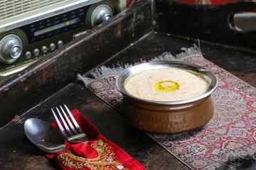 Hareesa or harees arab dish served in dish isolated on red mat top view on table arabic food © Food Shop