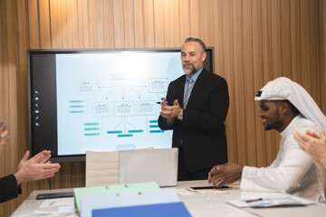 Business people, laptop and clapping hands in meeting for proposal, logo or reveal in office. Team, applause and corporate success by group celebrating achievement, project and job well done together