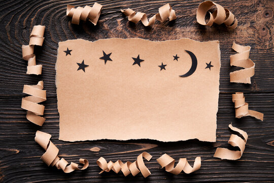 Ripped piece of paper with moon and stars, paper art style. Greeting card, invitation mockup