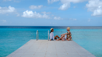Men and women on the beach of Playa Porto Marie Beach in Curacao, a tropical beach on the Caribbean...