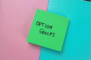 Concept of Option Greeks write on sticky notes isolated on Wooden Table.