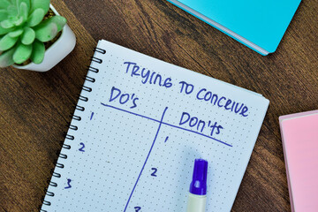 Concept of Trying to Conceive Do's and Don'ts write on book isolated on Wooden Table.