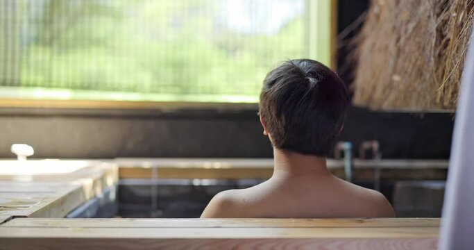 Asian man enjoy bath in onsen hotel