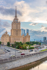 Fototapeta na wymiar high-rise stalinist building near river at summer sunset in Moscow, Russia. Historic name is Hotel Ukraine.