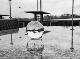 Crystal lens ball on stone table
