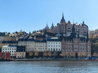 Panoramic view of Gamla Stan - the old town of Stockholm against the backdrop of water and blue sky.
