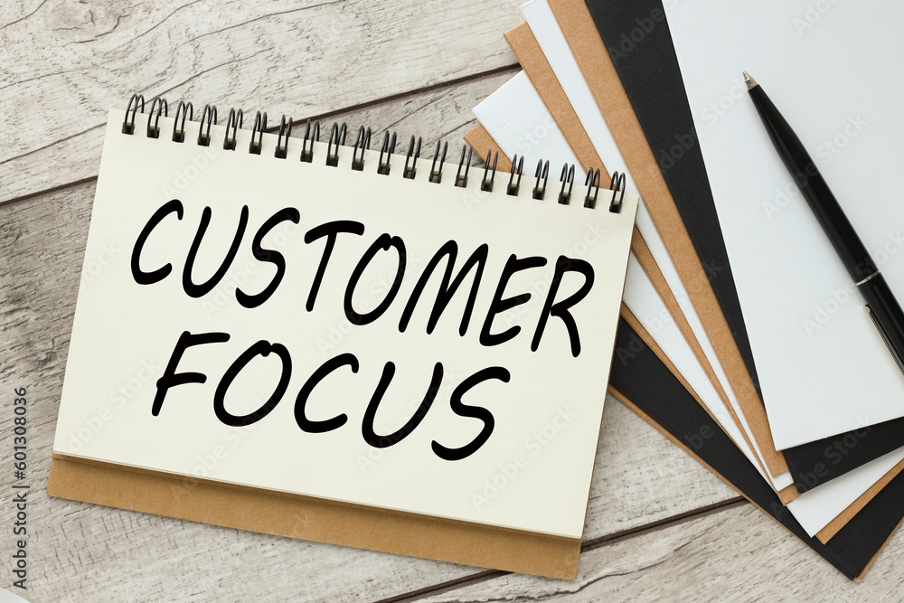 Poster customer focus text on notepad desktop top view