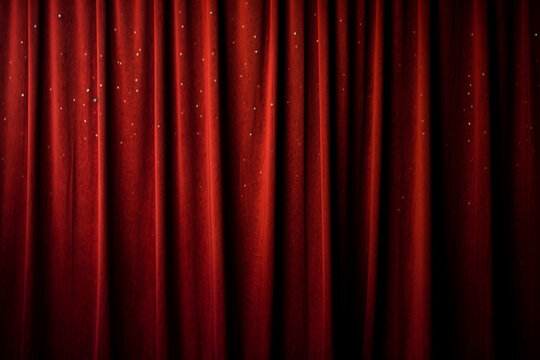 Background of red spotted real theatrical curtain or drapes texture