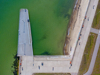 Aerial view landscape Poland Gdynia. Baltic sea, green water, seaside boulevard. Road by the beach. The pier.