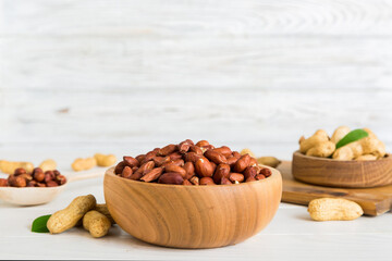 Fresh healthy peanuts in bowl on colored table background. Top view Healthy eating bertholletia concept. Super foods