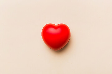 red heart shape on colored background. minimal concept top view with copy space