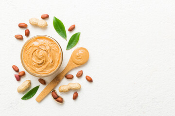 Bowl of peanut butter and peanuts on table background. top view with copy space. Creamy peanut pasta in small bowl