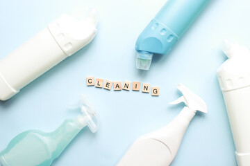 .Flat lay cleaning on a blue background. Cleaning tool mockup. Spray for cleanliness. The word purity is made up of letters