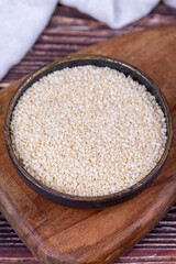Sesame seeds. Organic White Sesame seeds (Sesamum indicum) on wooden background. Close up