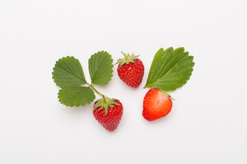 Strawberries with leaves on white background, top view