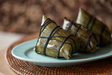 Three cooked rice dumplings on a plate