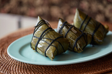 Three cooked rice dumplings on a plate