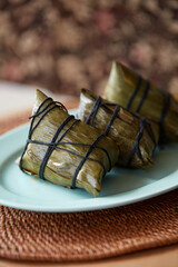 Three cooked rice dumplings on a plate