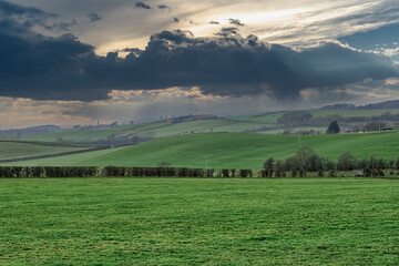 Fototapeta na wymiar Scottish Fields as the heavy Rain comes over the far hills in the hazy distance.