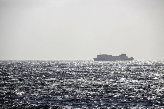 evocative image of a ferry moving on the high seas