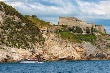 Ancient Doria Castle and tourist ferry to the Cinque Terre in Porto Venere or Portovenere town,...