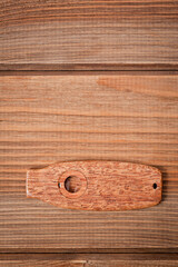 Kazoo is a musical wind instrument made of wood, filmed on a wooden surface.