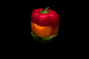Colorful slices of sweet pepper on black background