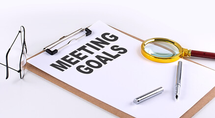 MEETING GOALS text on clipboard on white background, business concept
