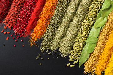 Set of flavors on blackboard background, top view. Spices for cooking tasty food.