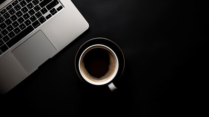 Laptop and coffee cup on black background. Top view with copy space