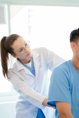 Fototapeta premium Patient at the physiotherapy doing physical exercises with docter therapist.