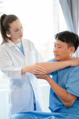 Patient at the physiotherapy doing physical exercises with docter therapist.