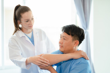Patient at the physiotherapy doing physical exercises with docter therapist.