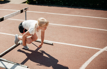Sports girl in sportswear, runs a school marathon, the concept of a healthy lifestyle.