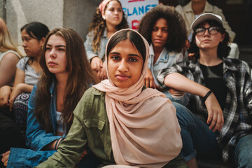 Muslim girl sitting with a group of activists