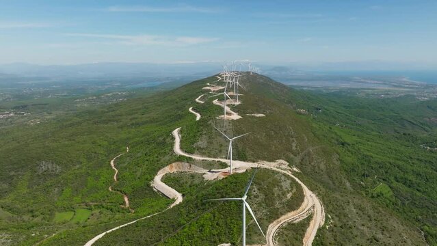 a lot of wind turbines on the ridge of the mountains in Montenegro. aerial view. Sunny summer day