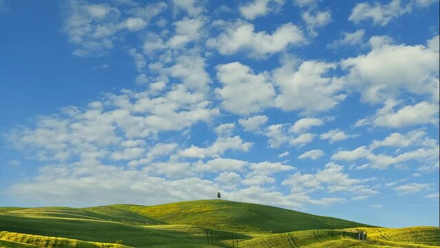 Green hills and blue sky with clouds, Val d'Orcia in Tuscany, Italy, 4k time-lapse video