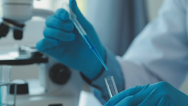 biochemical research scientist team working with microscope for coronavirus vaccine development in pharmaceutical research labolatory, selective focus