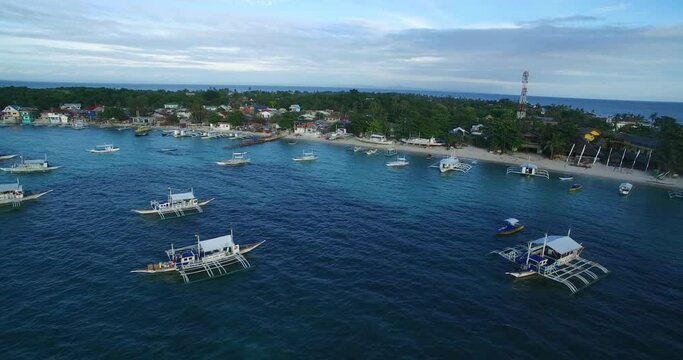 Logon Beach and Boats in Malapascua Island Seashore in Cebu, Philippines. Sulu Sea, Boats and Beautiful Seascape in Background. Drone 4k