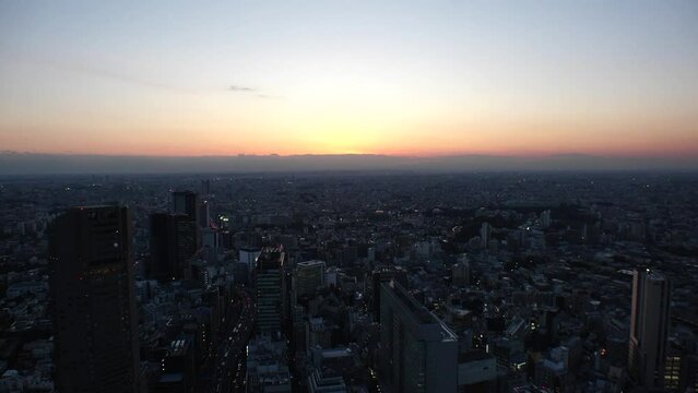 TOKYO, JAPAN : Aerial high angle sunset or sunrise CITYSCAPE of TOKYO. View of buildings around Shibuya. Japanese city life and nature concept. Colorful gradation sky. Real time shot.