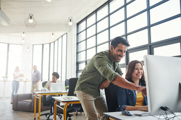 Mentorship, man and woman in coworking space with smile and advice at creative start up agency. Computer, desk and happy team leader coaching for designer internship in office with help and opinion.