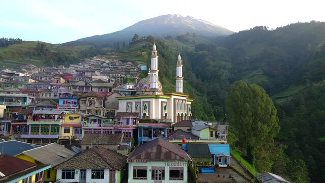 Amazing view of Mosque on nepal van java and peak of Mount Sumbing in sunny morning. Baitut taqwa mosque on Nepal Van Java, Indonesia. Beautiful rural landscape - 4K drone video
