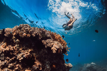 Woman with mask dive to the corals in tropical blue sea. Snorkeling with woman in Hawaii - obrazy, fototapety, plakaty