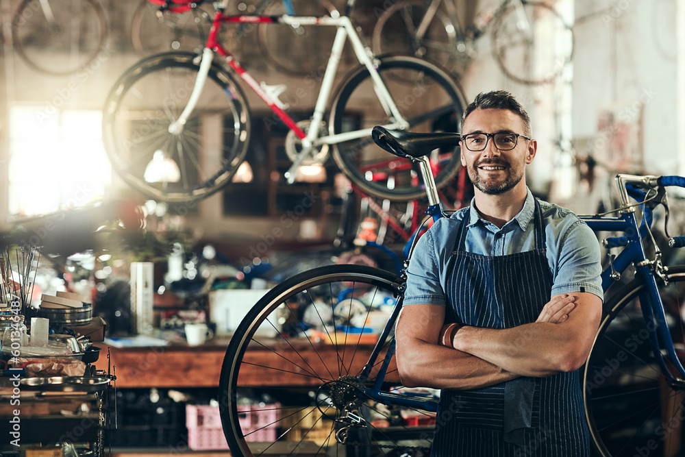 Canvas Prints Portrait, smile and repair man in bicycle shop with arms crossed working in store. Face, bike mechanic and confident male person from Canada with happiness, glasses and mature in cycling workshop.