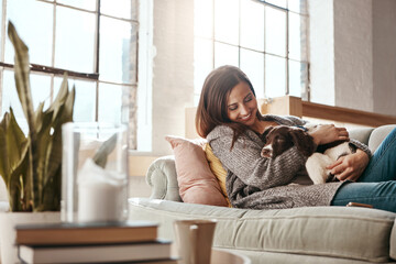 Smile, dog and woman on a couch, relax and love with joy, playful and carefree at home. Female...